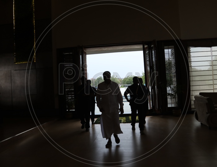 Silhouette of People Entering Into Room From Main Door