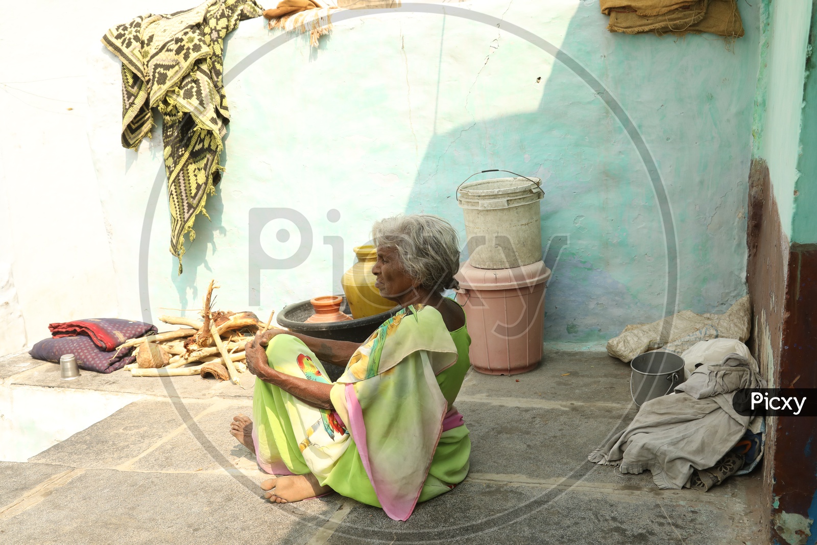 An old women sitting on the floor