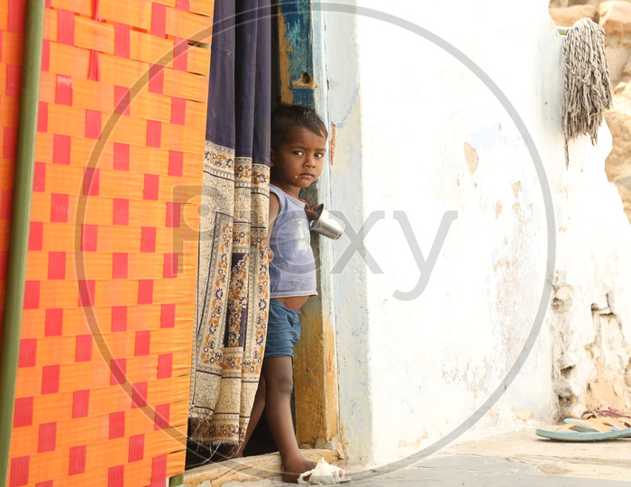 A Small Child Standing at Door Entrance