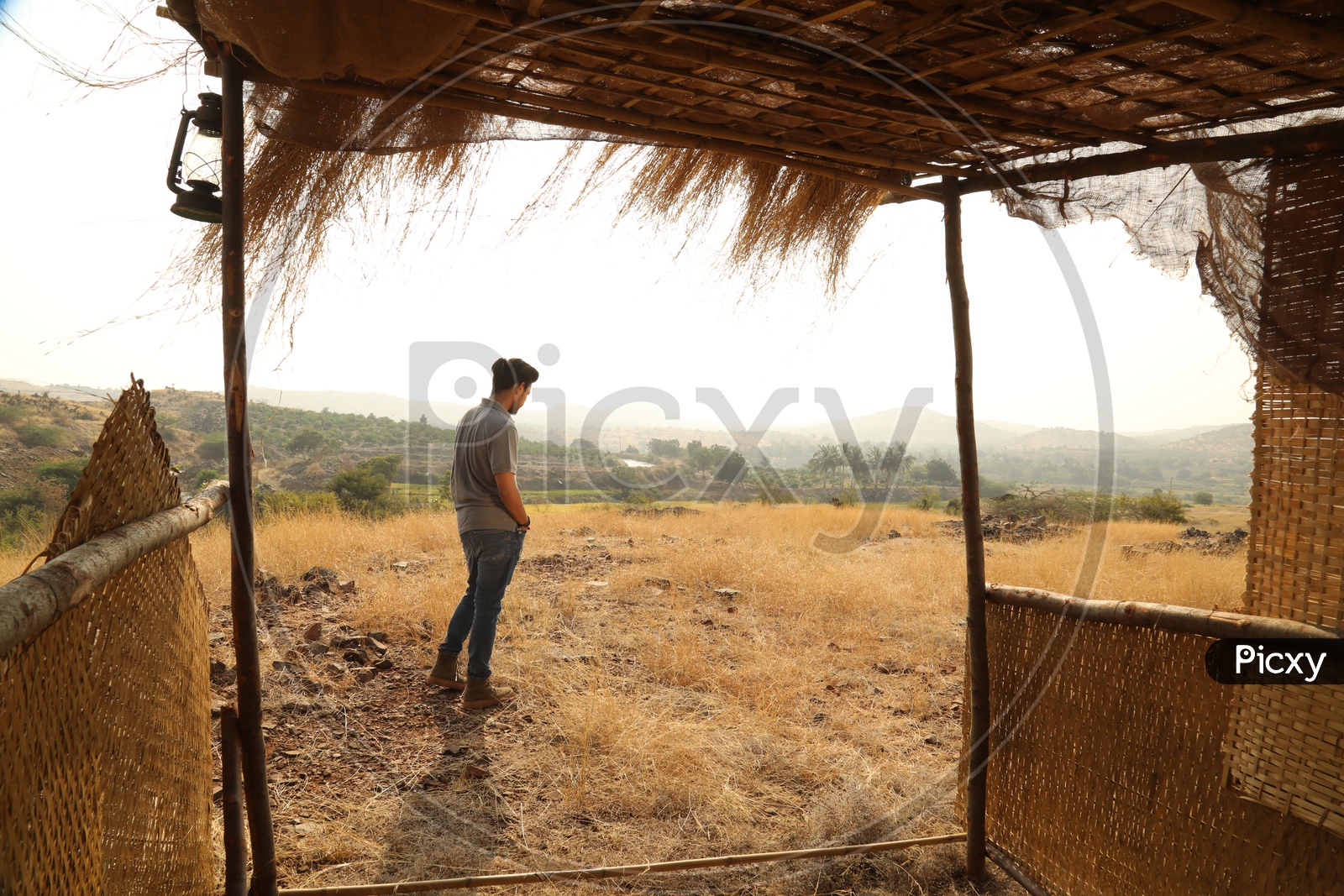 A man seen through the nipa hut in the open area