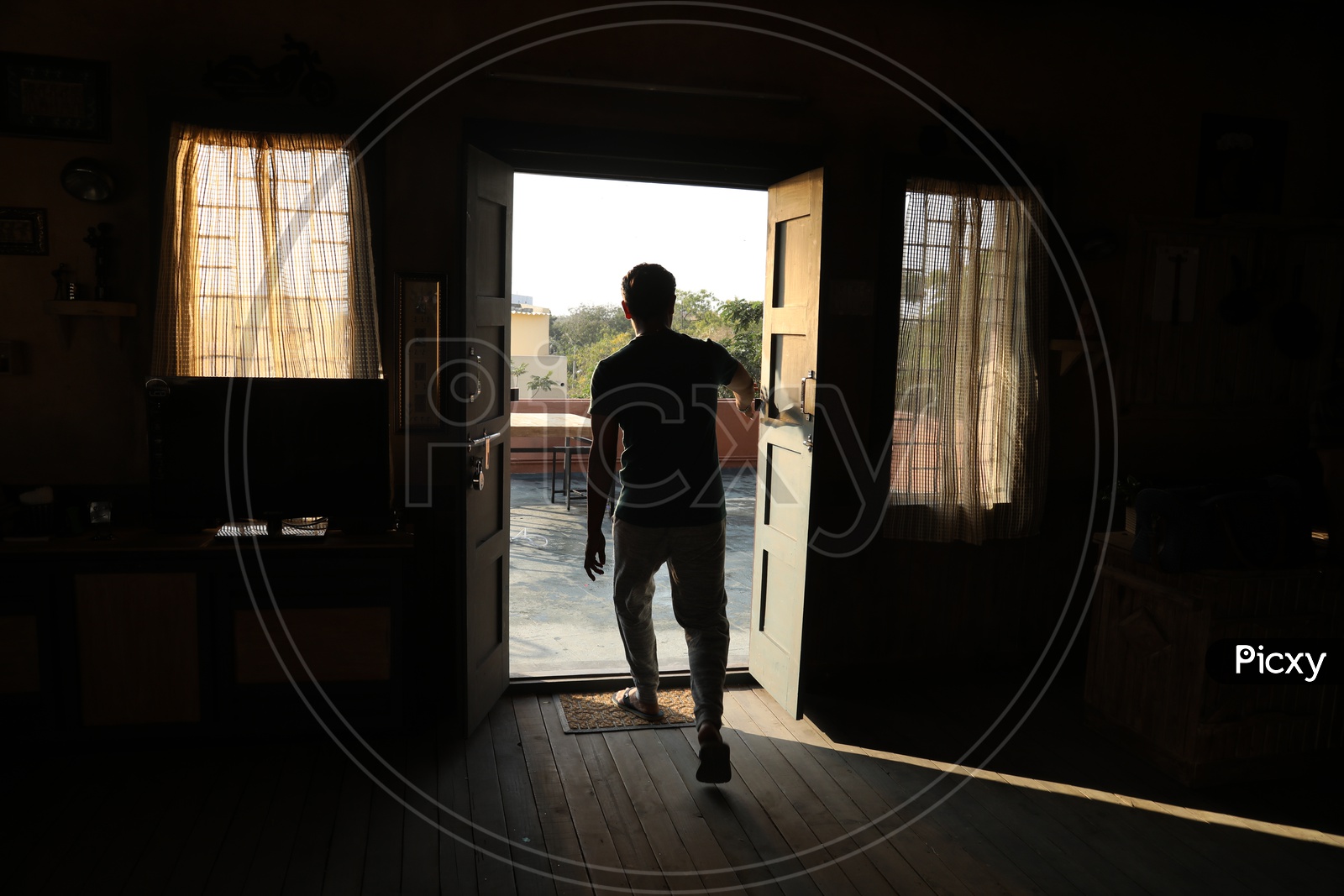 Silhouette Of a man Standing At Door Entrance