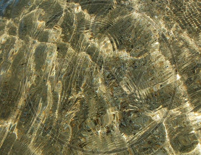 Transparent water surface on sand