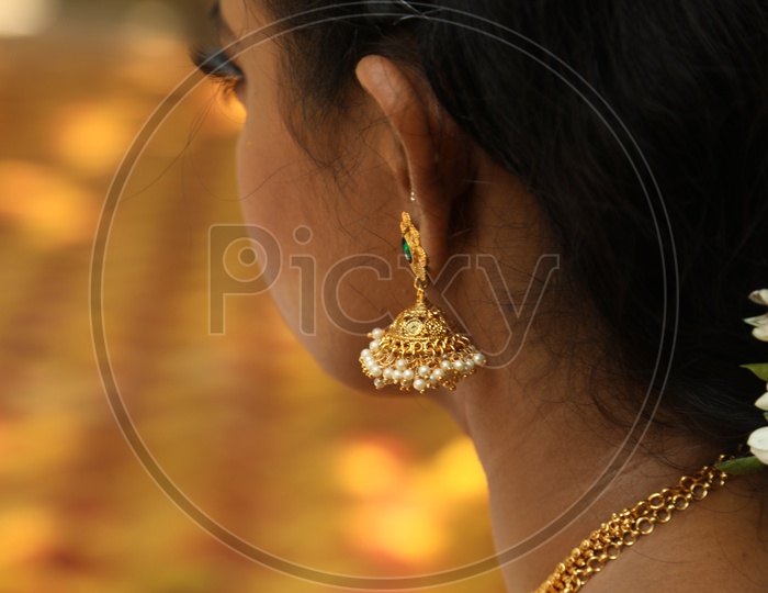 Close up shot of jhumka on Indian women ear