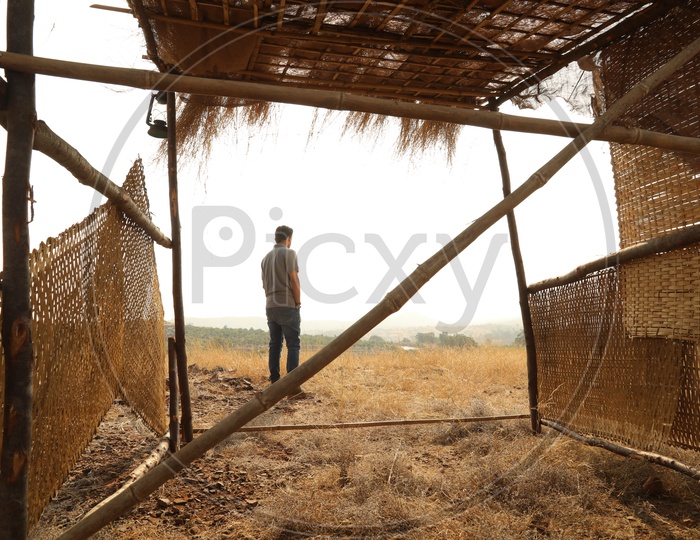 A man seen through the nipa hut in the open area