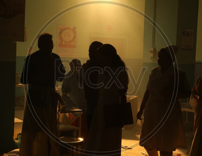 Silhouette Of Nurses And Patients in a Hospital Room
