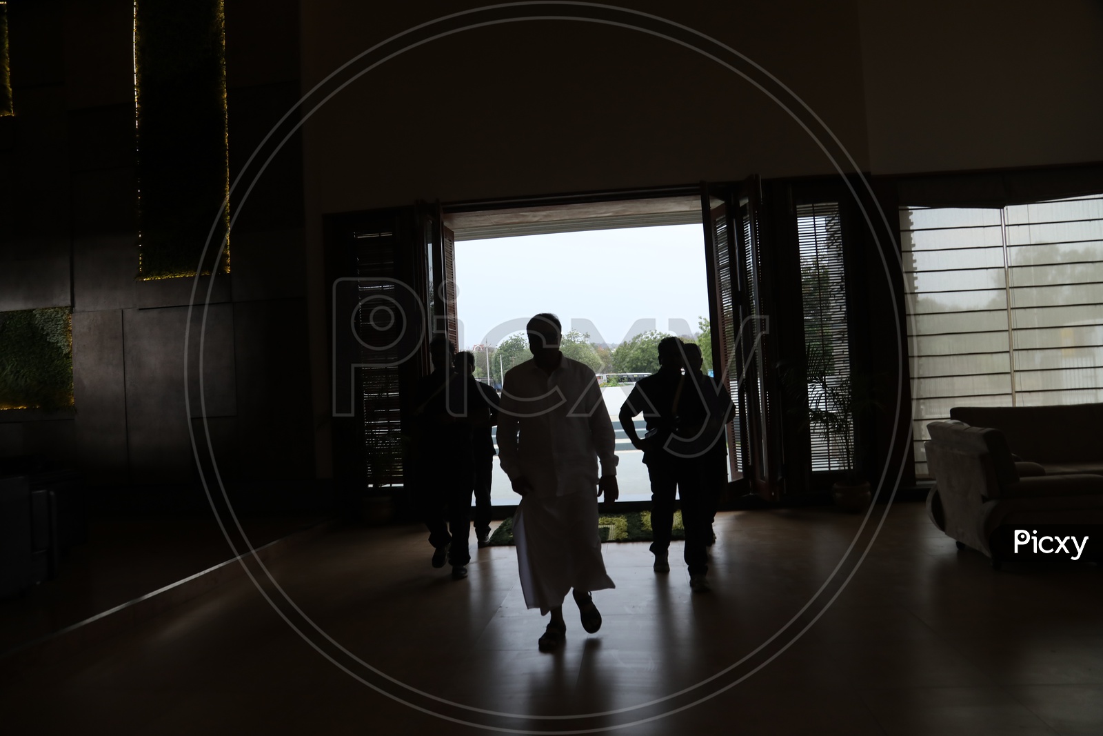 Silhouette of People Entering Into Room From Main Door