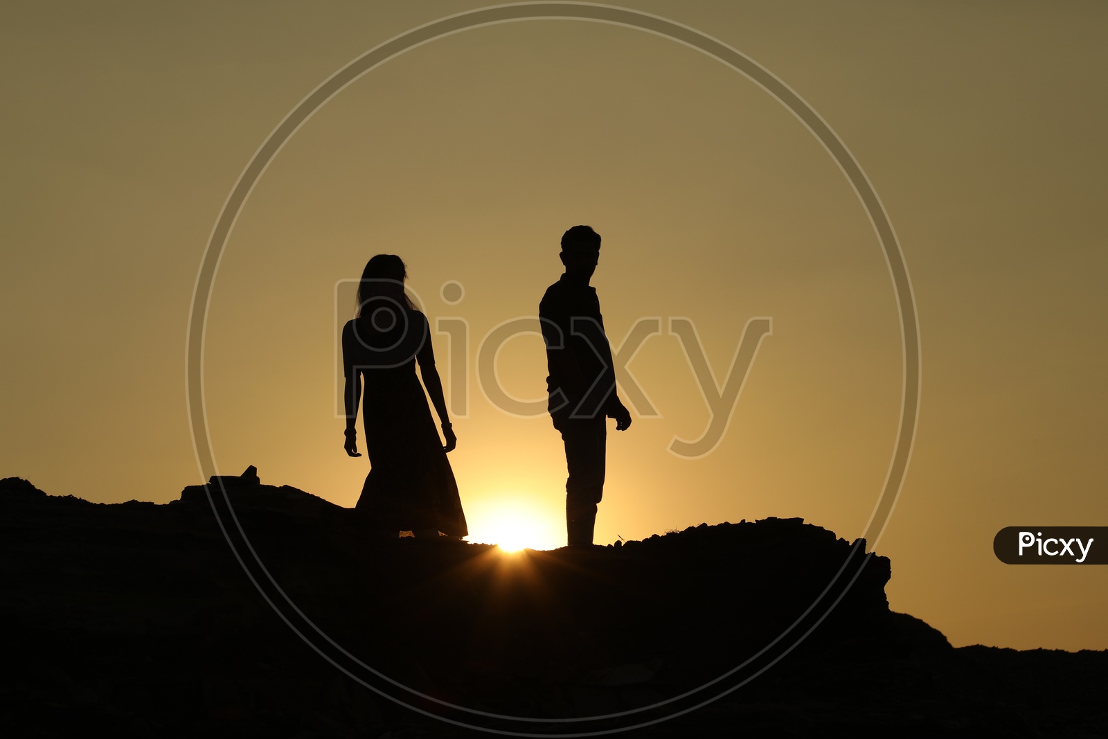 Silhouette  of a couple with sun in background
