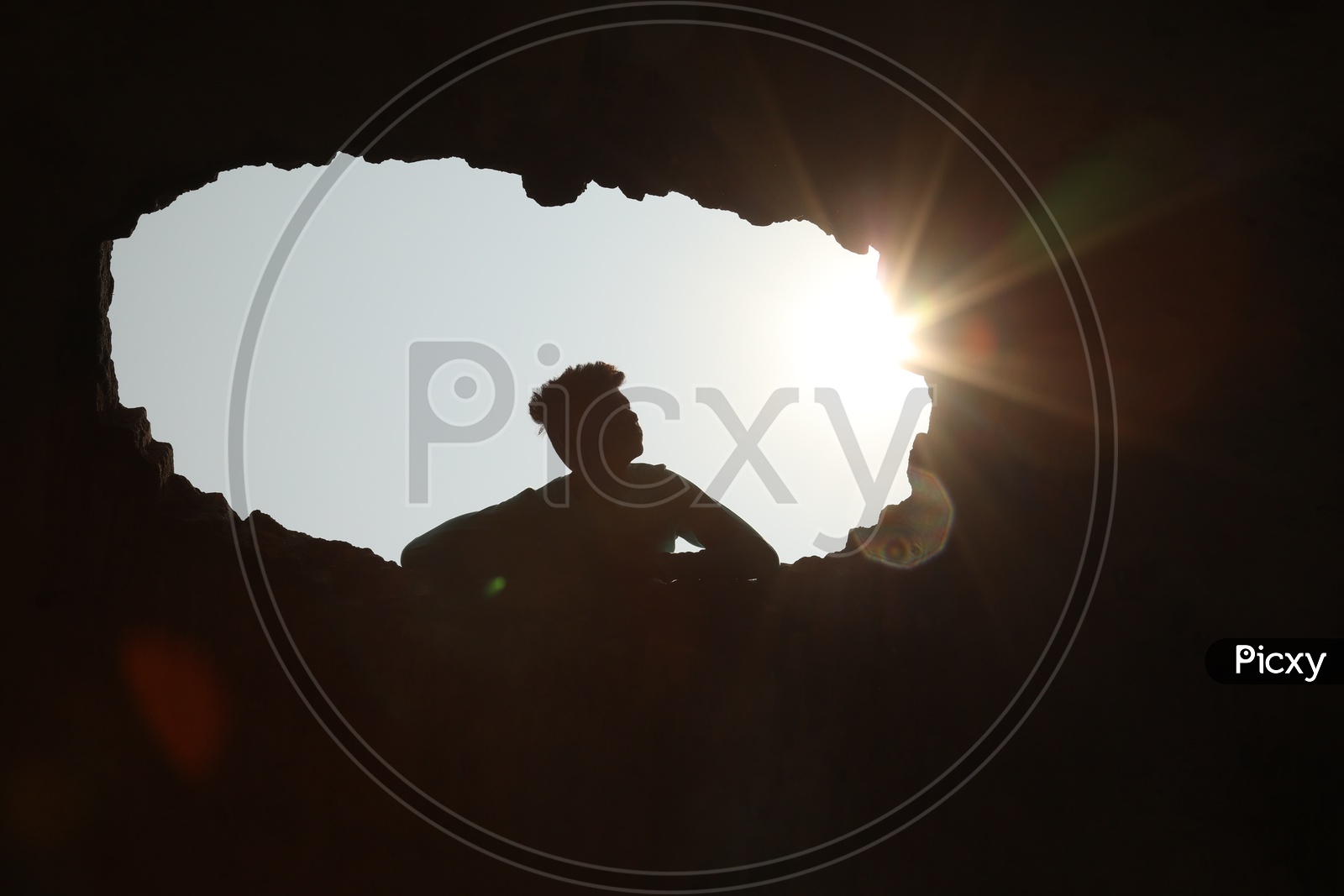 Silhouette Of a Young Boy Over Bright Sun