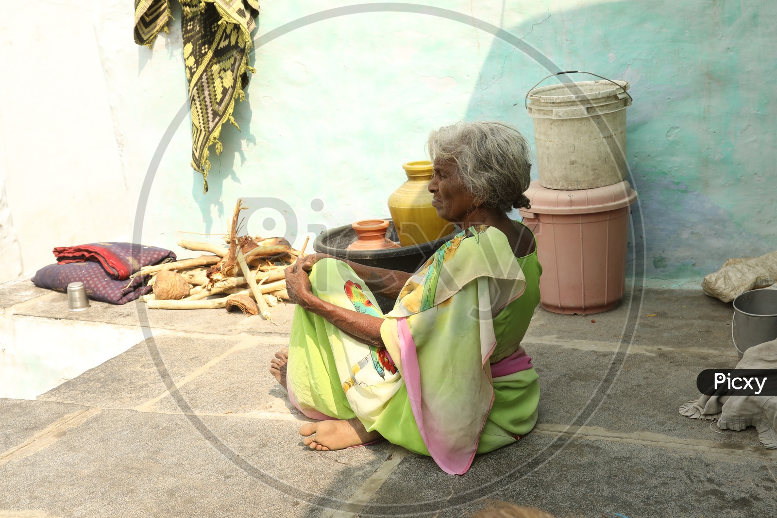Indian old woman sitting on the floor