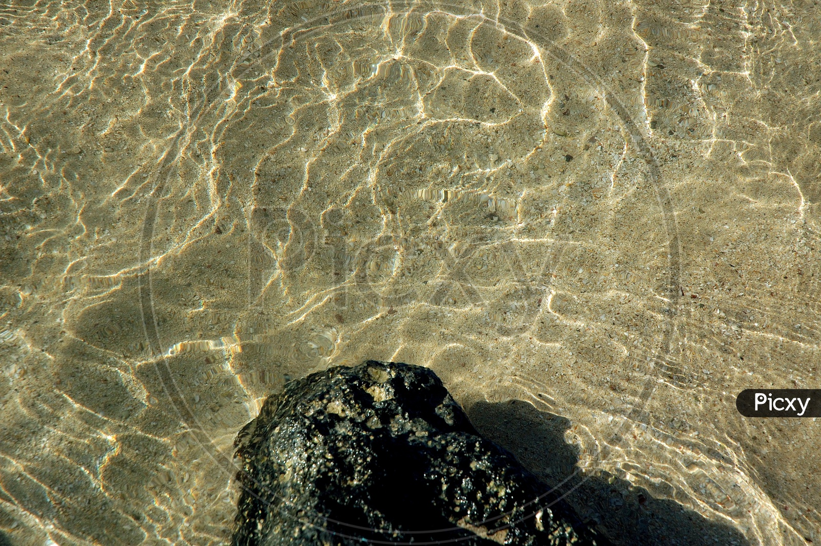 Transparent water surface on the sand