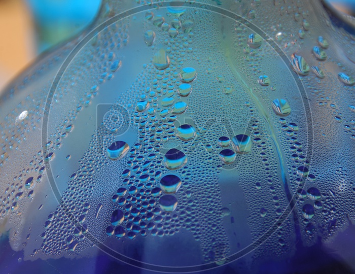 Water droplets inside a blue glass bottle