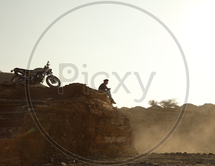 A man with the bike at Black stone mining area