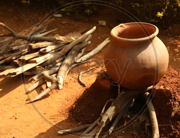 Clay pot cooking on an Indian stove using wood
