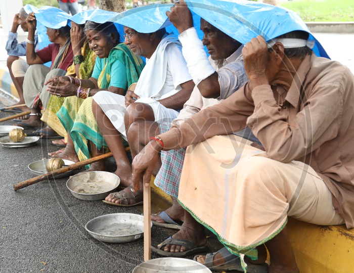 Beggars Sitting On Road Side Platform