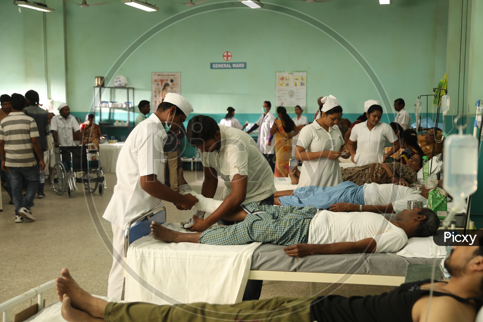 Nurses Treating Patients In A Hospital Ward