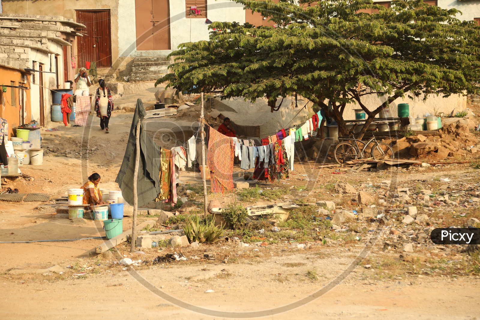 A woman washing clothes in a slum area