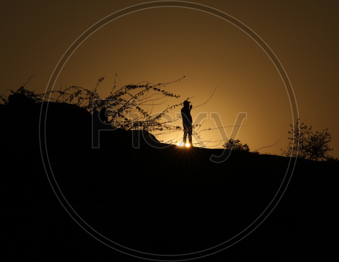 Silhouette of a man on hill