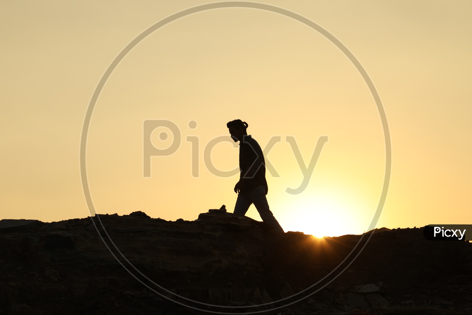 Silhouette of a man with sun in background