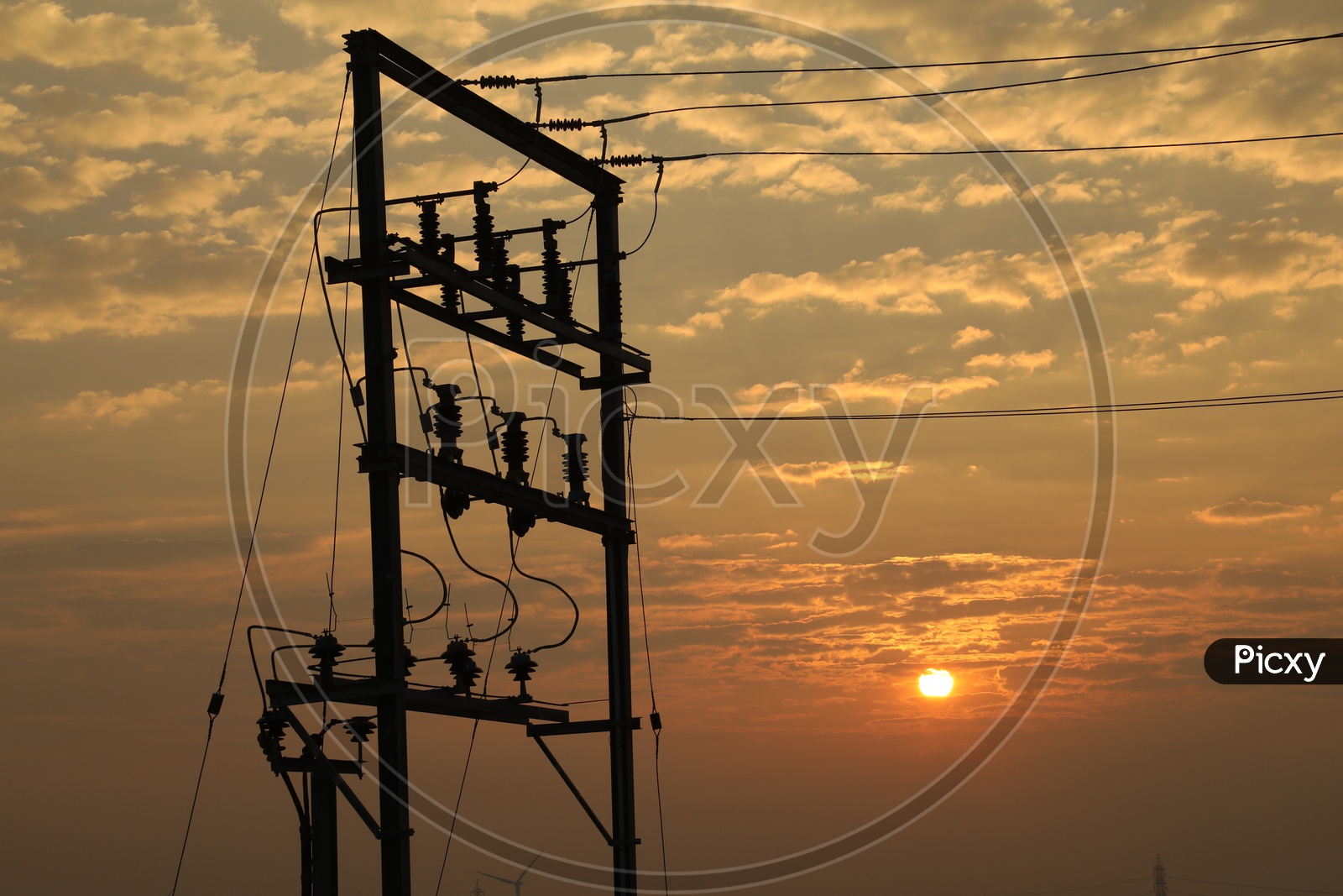 Sunset with electrical transformer in foreground