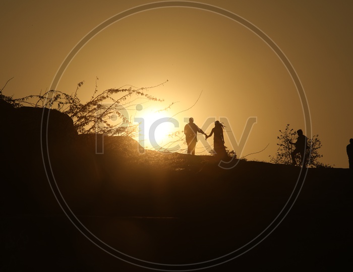 Silhouette of people on hill