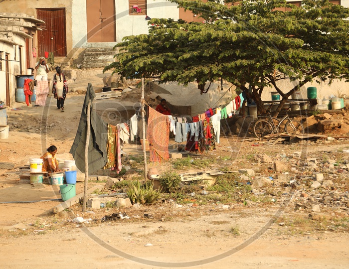 A woman washing clothes in a slum area