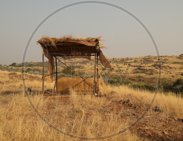 Nipe hut with dry steppe grass in the open area with mountains in the background