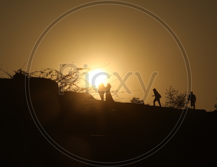 Silhouette of people running on hill