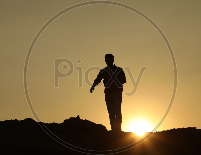 Silhouette  of a man with sun in background