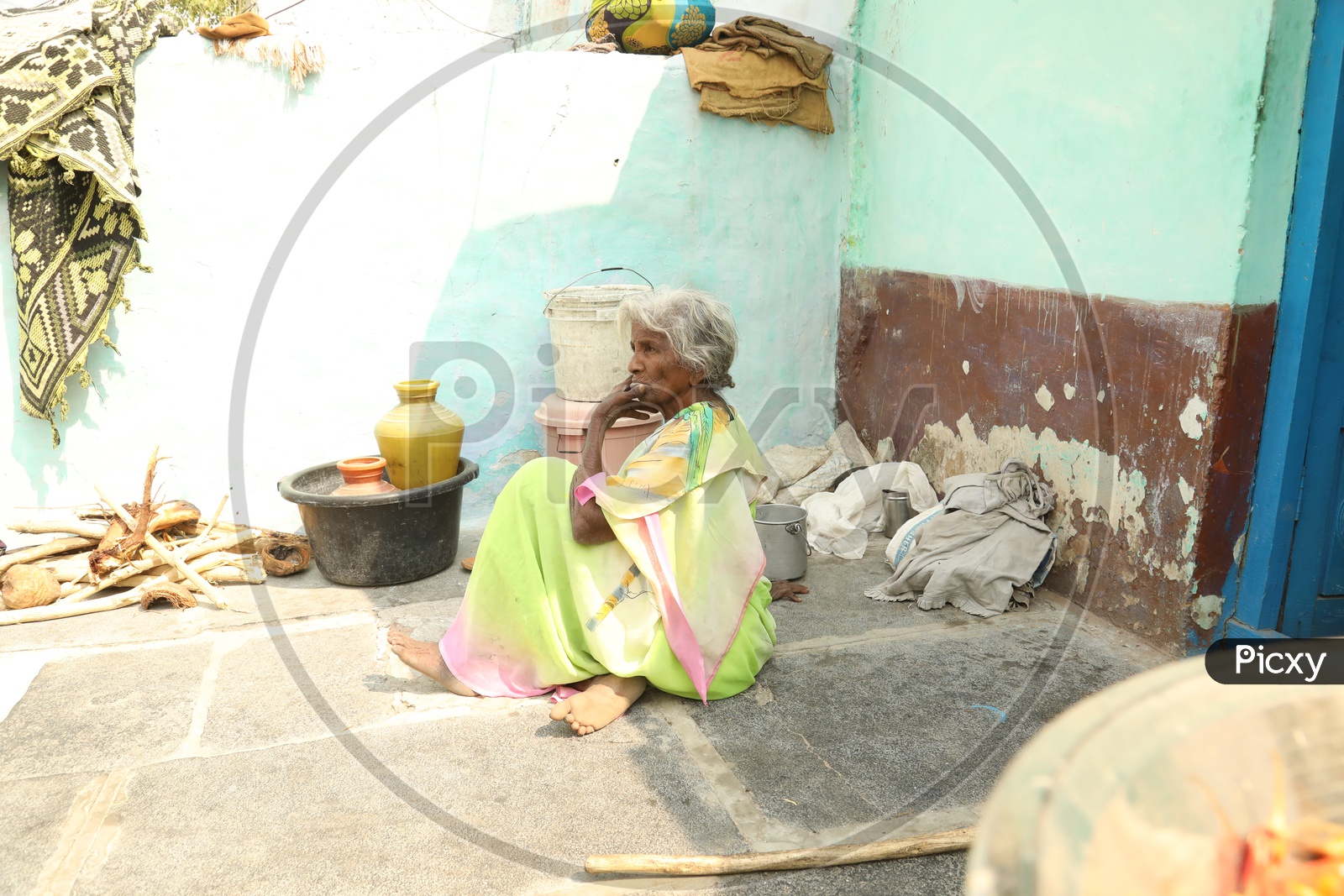 Indian old woman sitting on the floor
