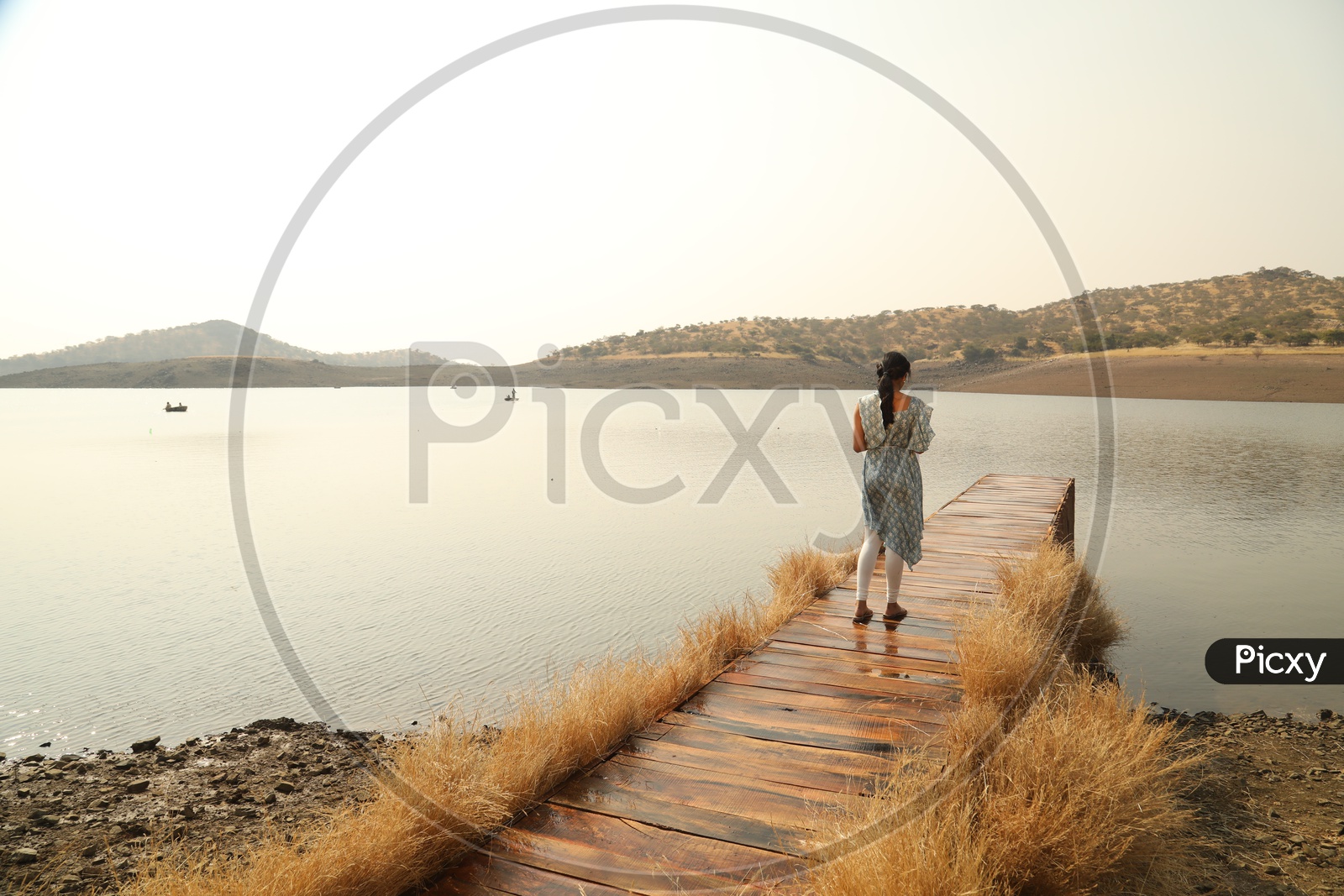 A Young Girl Standing On a Wooden Water bridge
