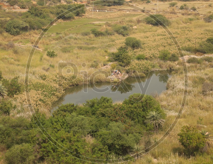 Aerial View Of a Water Pond In Barren Lands In Village Outskirts