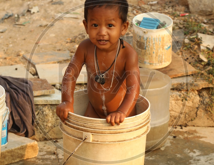 Kid bathing in a bucket