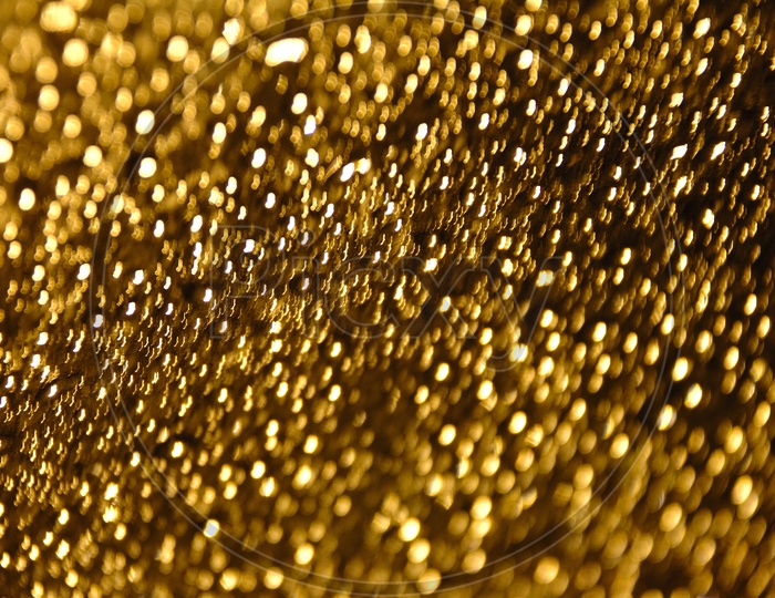 Bokeh of water droplets golden yellow abstract background