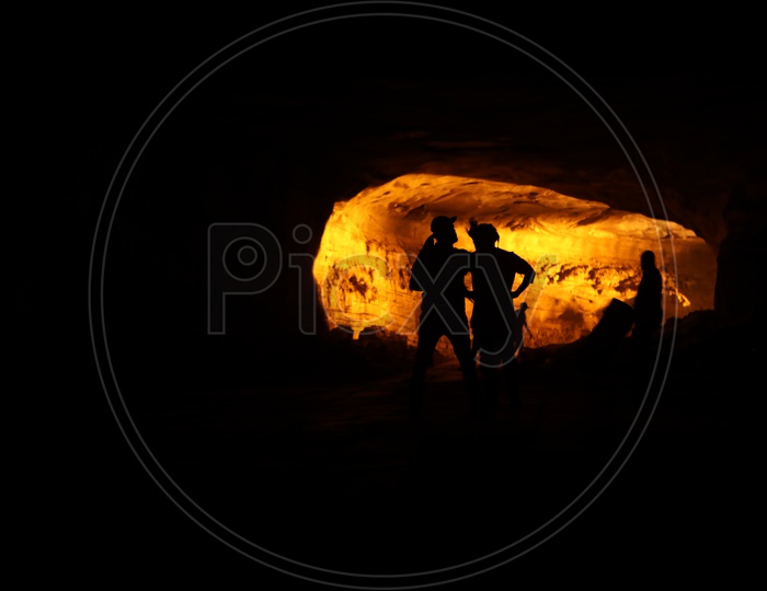 Silhouette of men in the cave