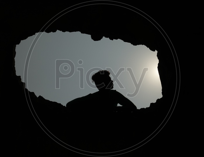 Silhouette Of a Young Boy Over Bright Sun