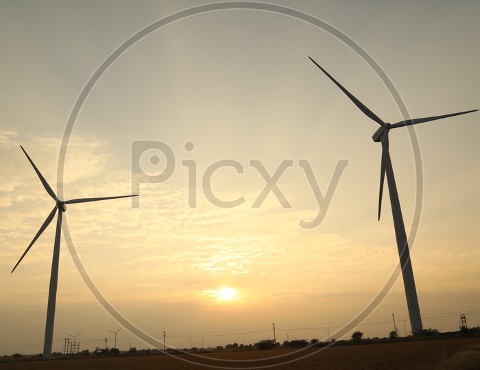 Silhouette of wind turbine on sunset