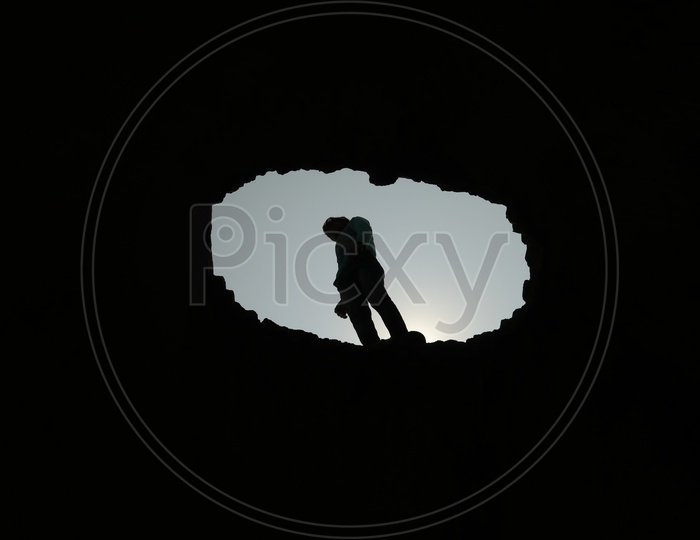 Silhouette Of a Young Man Standing Over A Bright Sun