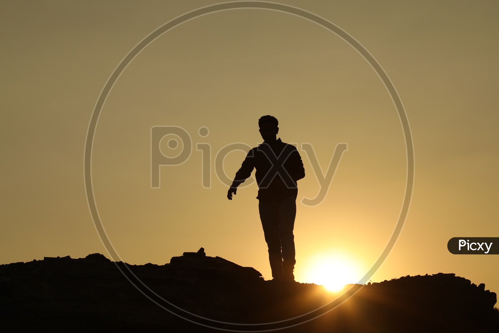Silhouette  of a man with sun in background