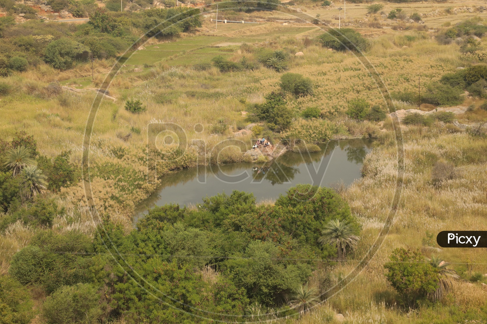Aerial View Of a Water Pond In Barren Lands In Village Outskirts