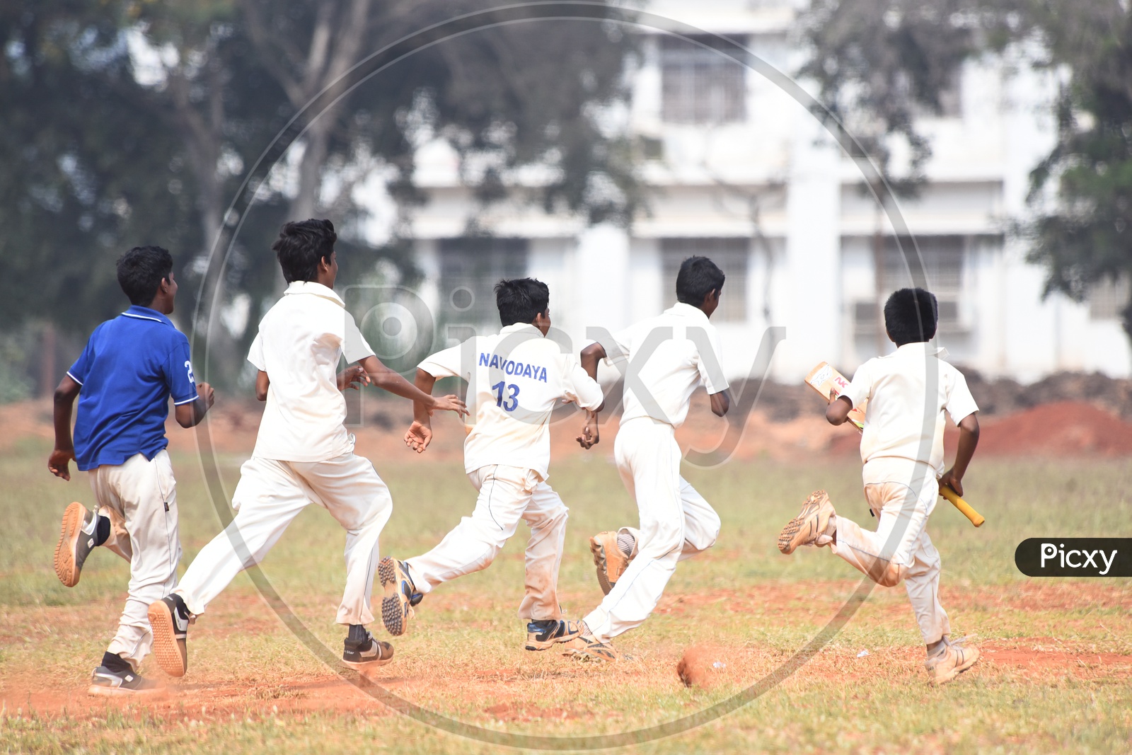School cricket players running in the ground