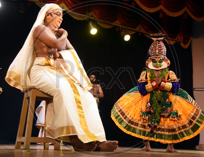 Artists performing Indian Classical Dance form Kathakali on stage