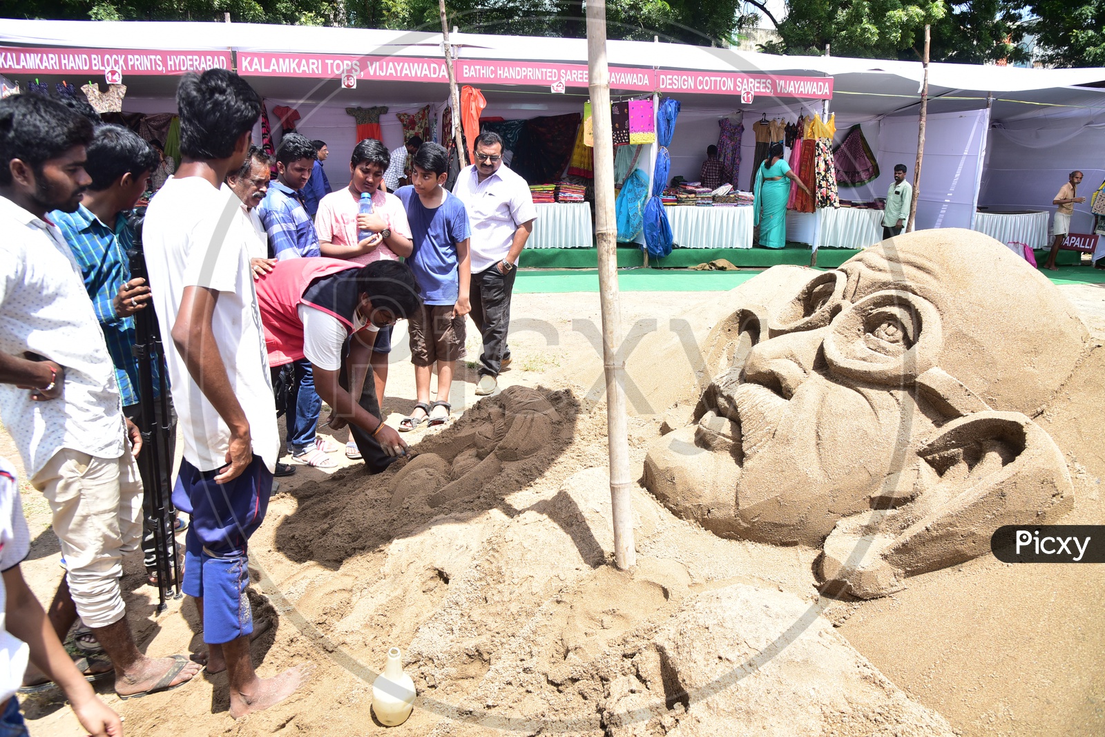 Sand Artist sculpting Gandhi Sculpture