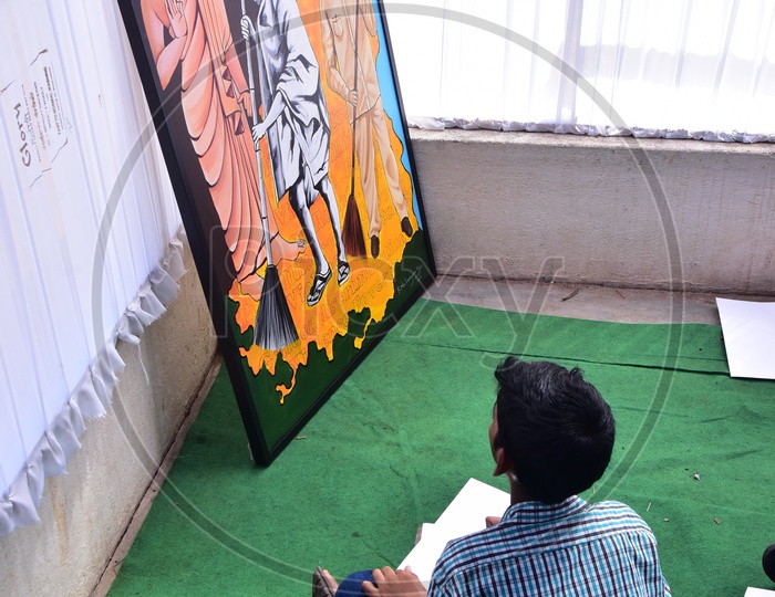 School kid drawing a sketch during a competition