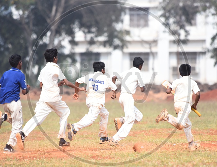 School cricket players running in the ground