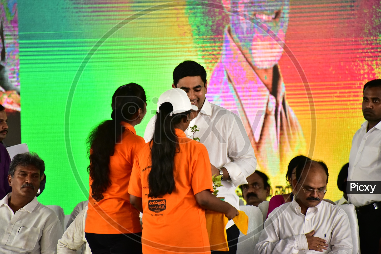 Girls distributing plants to Nara Lokesh during the launch of Swachh Andhra Mission