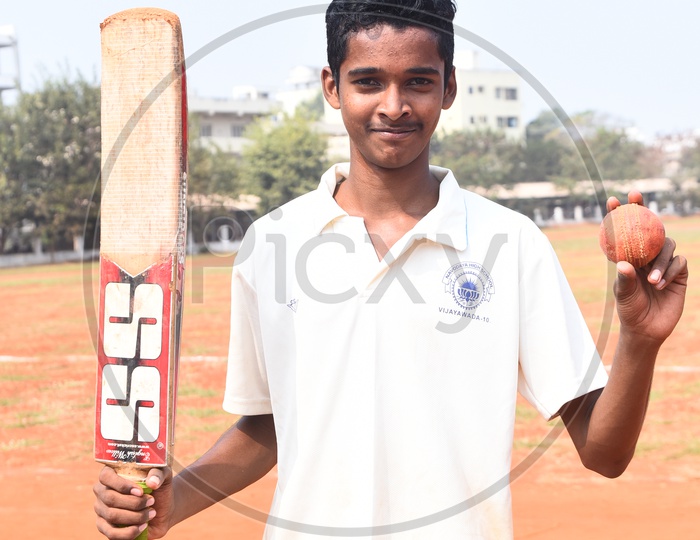 School cricket player with a bat and ball