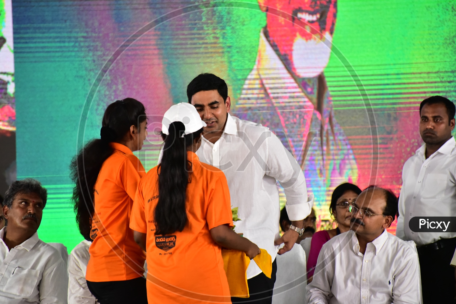 Girls distributing plants to Nara Lokesh during the launch of Swachh Andhra Mission
