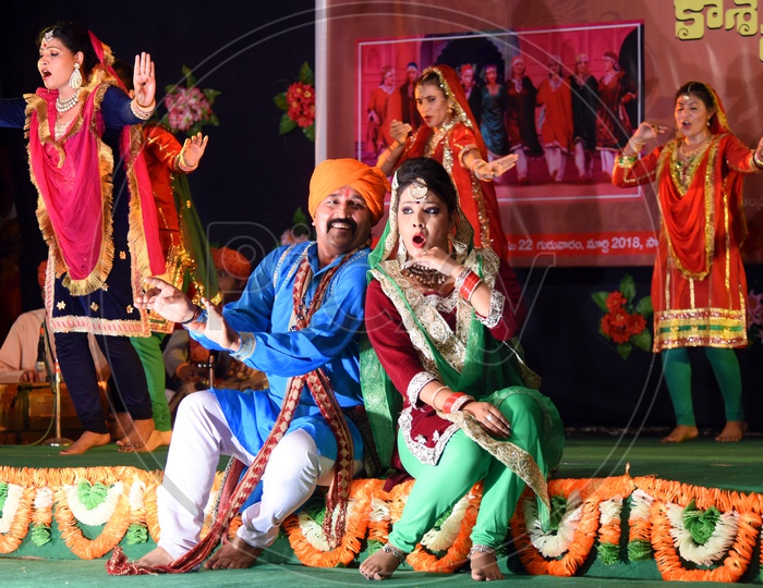 Artists performing Bhand Jashan dance on stage