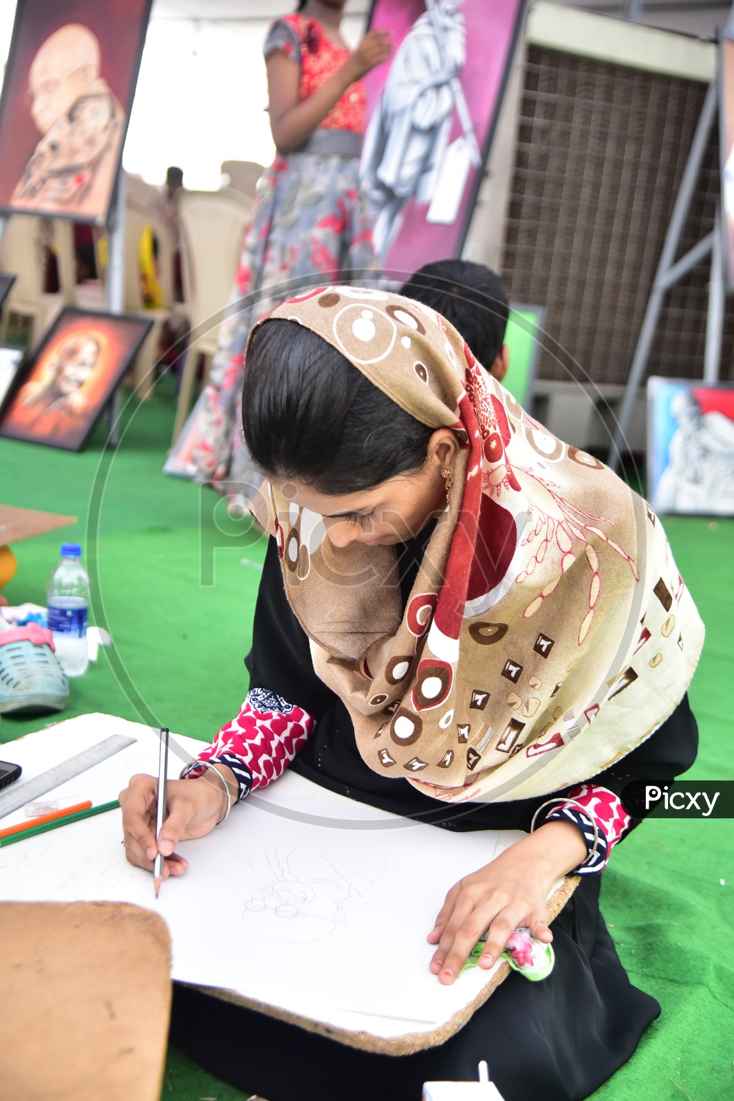 Muslim girl drawing a sketch during competition