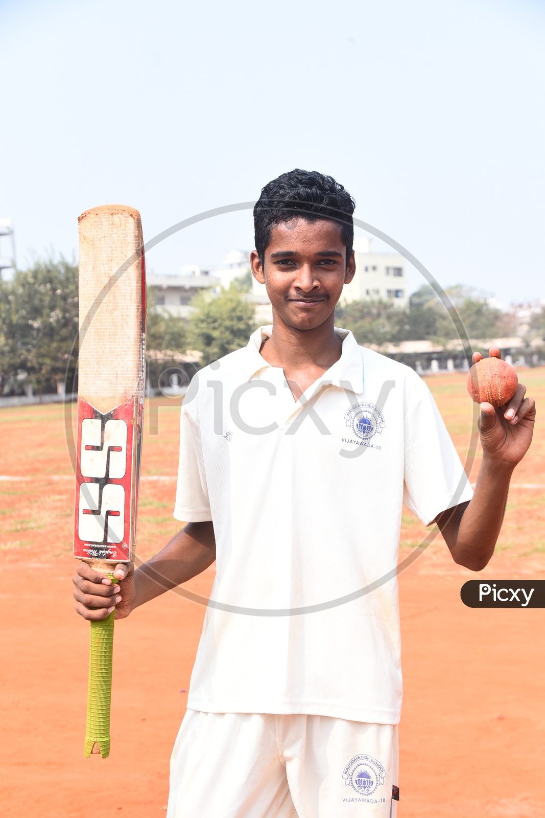 School cricket player with a bat and ball